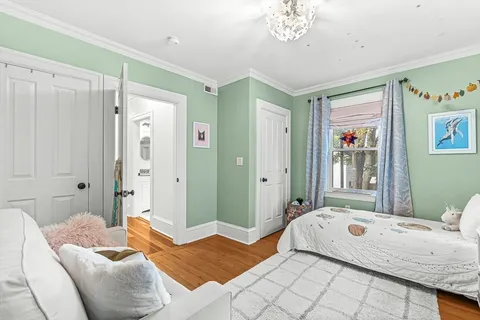 a bedroom with a bed and a chandelier