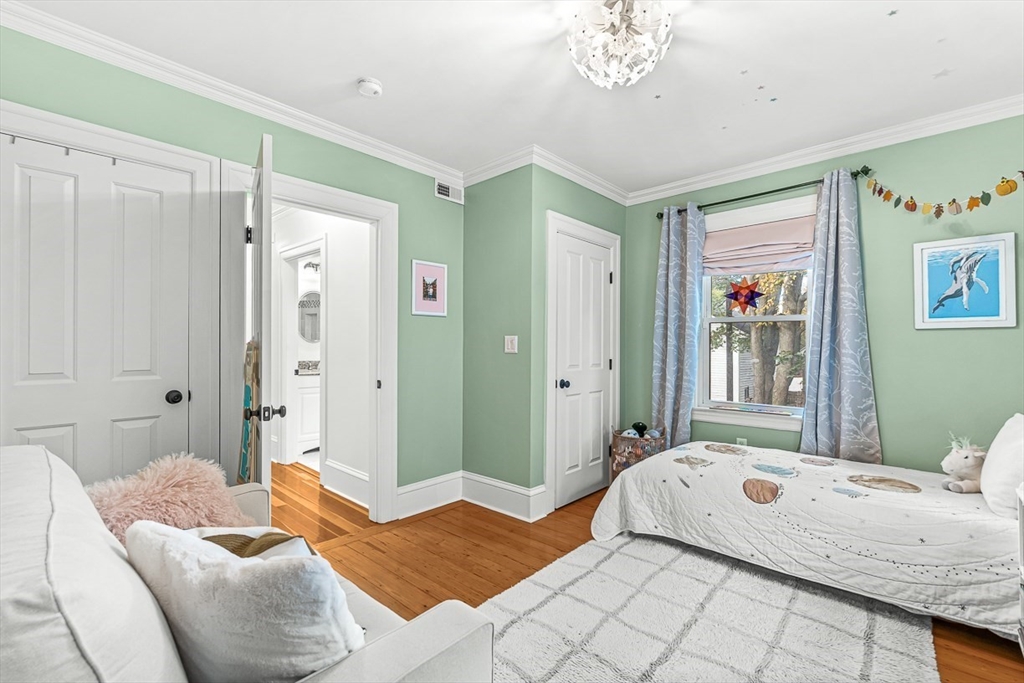 209 Washington Street, Unit 209 Winchester, MA 01890 - Photo 13 of 35 a bedroom with a bed and a chandelier