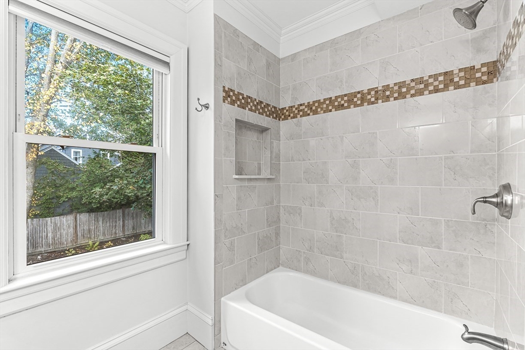 209 Washington Street, Unit 209 Winchester, MA 01890 - Photo 15 of 35 a bathroom with a bathtub and a shower
