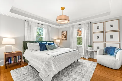 a bedroom with a bed a couch and a window