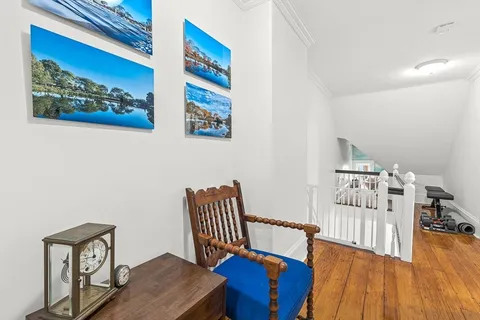 a bedroom with furniture and wooden floor