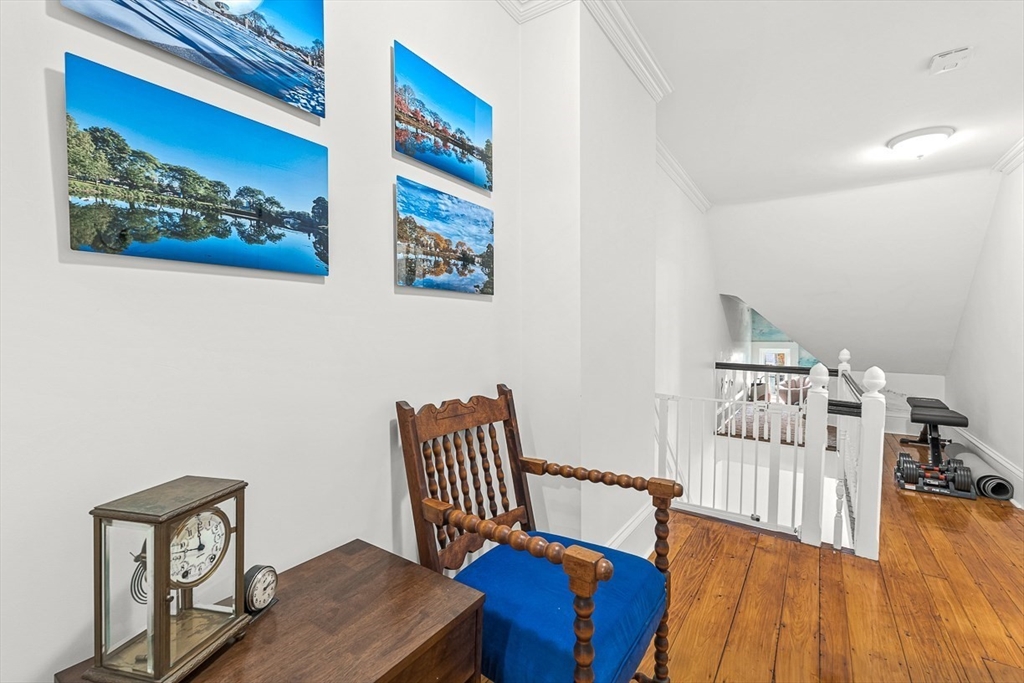 209 Washington Street, Unit 209 Winchester, MA 01890 - Photo 19 of 35 a bedroom with furniture and wooden floor