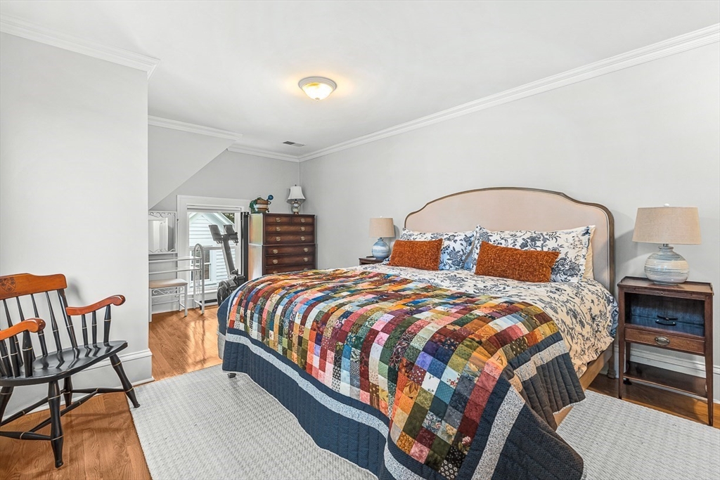 209 Washington Street, Unit 209 Winchester, MA 01890 - Photo 23 of 35 a bedroom with a large bed and two windows