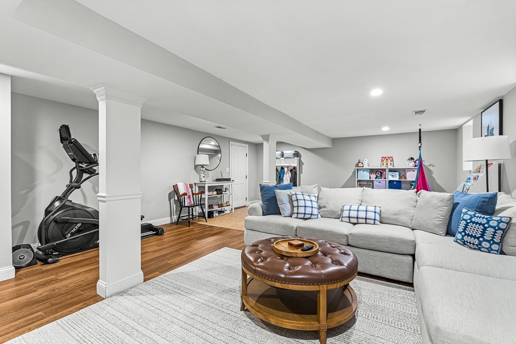 209 Washington Street, Unit 209 Winchester, MA 01890 - Photo 27 of 35 a living room with furniture and a wooden floor