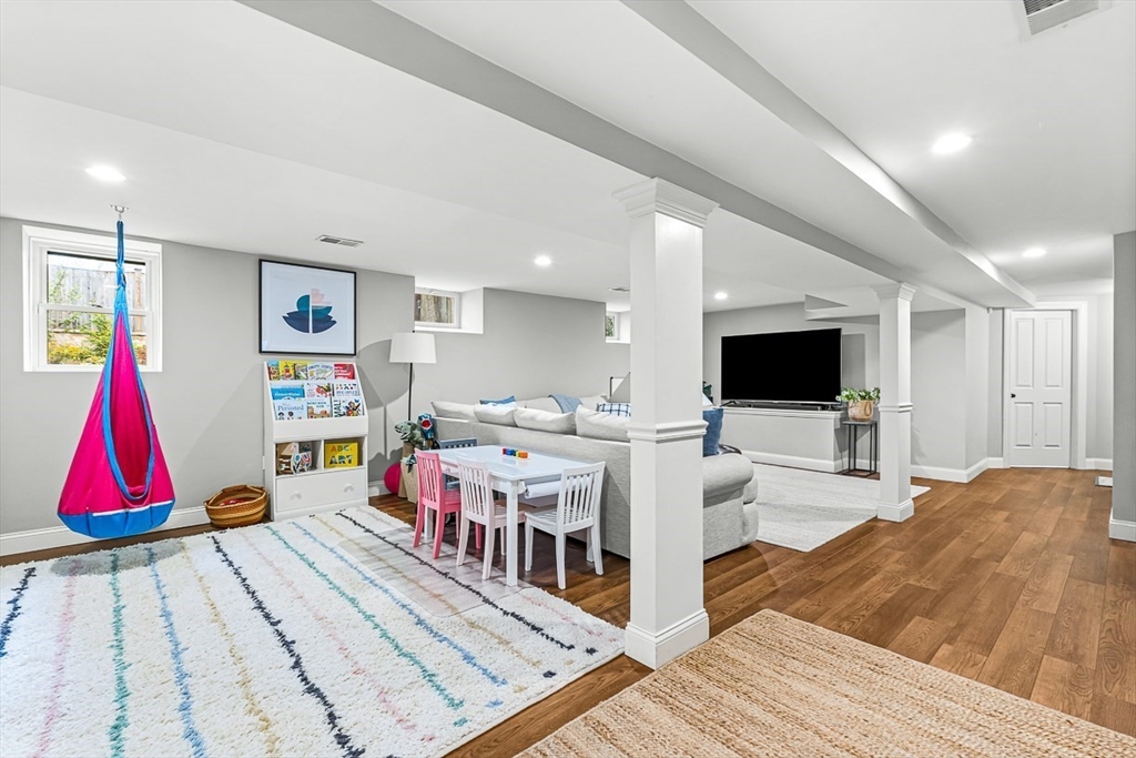 209 Washington Street, Unit 209 Winchester, MA 01890 - Photo 28 of 35 a living room with lots of white furniture and kitchen view