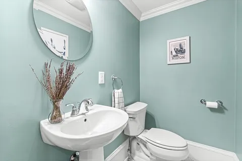 a bathroom with a toilet a sink and a mirror