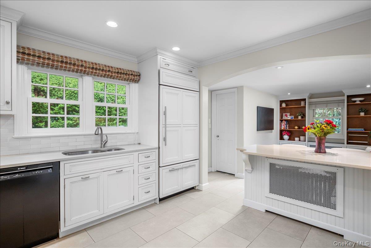 49 Eton Road Larchmont, NY 10538 - Photo 14 of 34 a kitchen with white cabinets and a sink