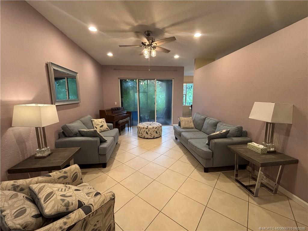 262 Southwest Walking Path, Unit 262 Stuart, FL 34997 - Photo 12 of 39 a living room with furniture and a lamp
