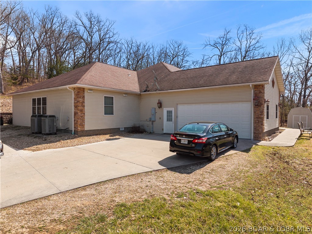 47 Mockingbird Road Lake Ozark, MO 65049 - Photo 51 of 65 garage and side house view