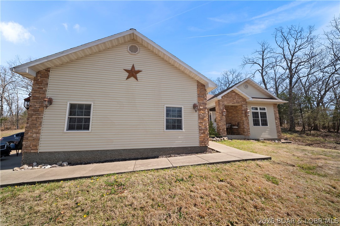47 Mockingbird Road Lake Ozark, MO 65049 - Photo 52 of 65 side of the house viewed from road