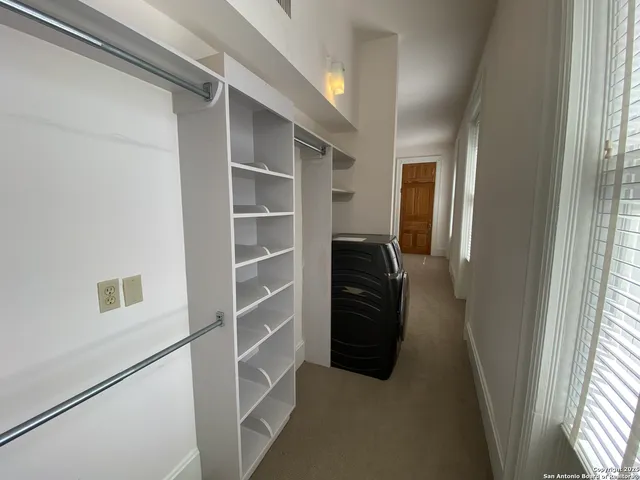 a view of closet area with empty racks