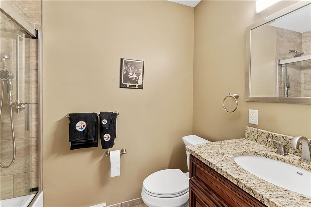 620 The Maples Farmington, PA 15437 - Photo 20 of 38 a bathroom with a granite countertop sink a mirror and a toilet
