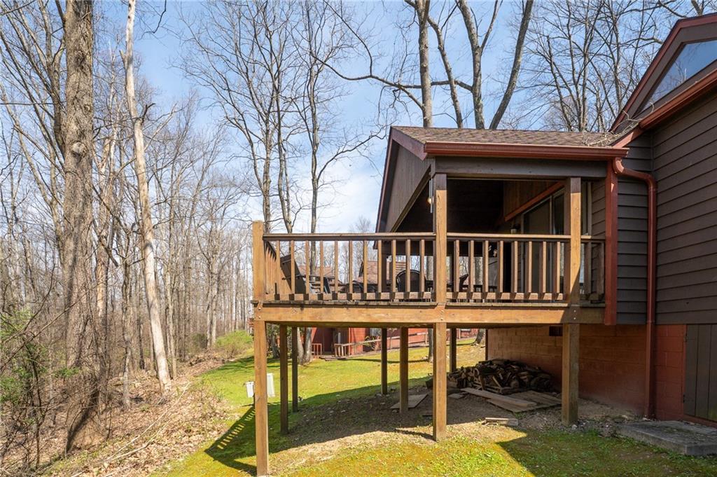 620 The Maples Farmington, PA 15437 - Photo 26 of 38 a view of a chairs and wooden deck in the backyard