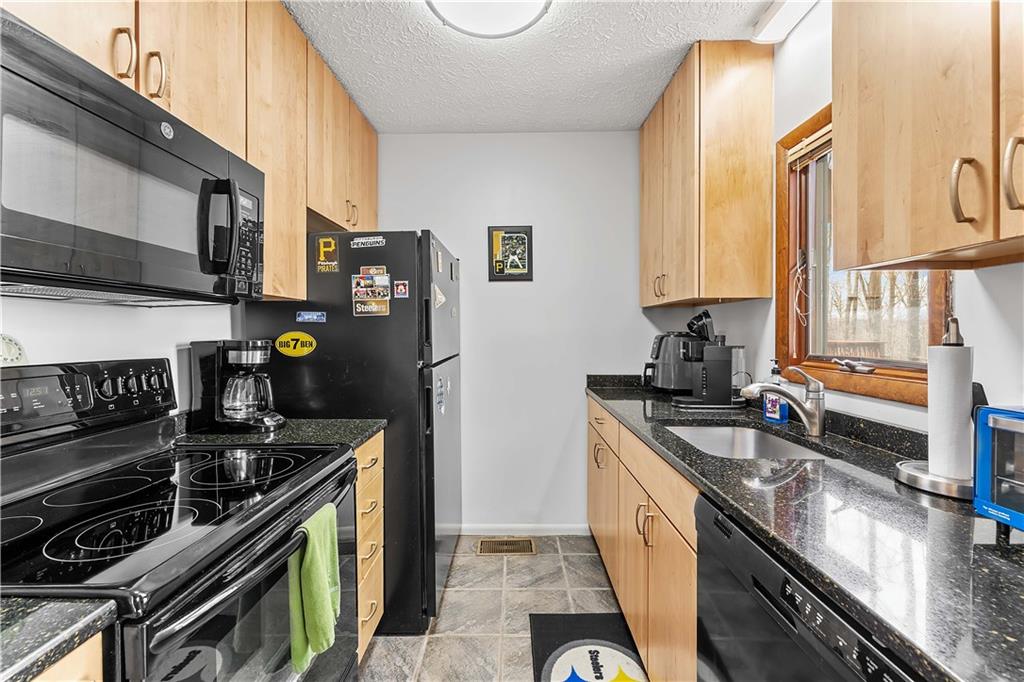 620 The Maples Farmington, PA 15437 - Photo 8 of 38 a kitchen with stainless steel appliances granite countertop a stove and a sink