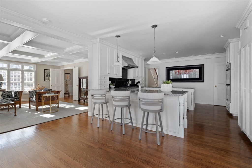 20 Risley Road Newton, MA 02465 - Photo 13 of 41 a view of a dining room and livingroom with furniture wooden floor a chandelier