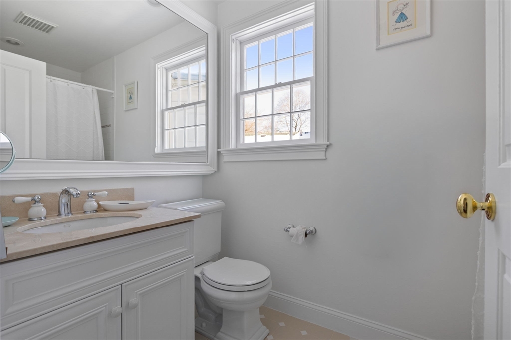 20 Risley Road Newton, MA 02465 - Photo 19 of 41 a bathroom with a granite countertop toilet sink and mirror