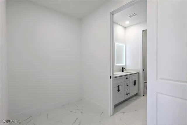 a bathroom with a double vanity sink and mirror