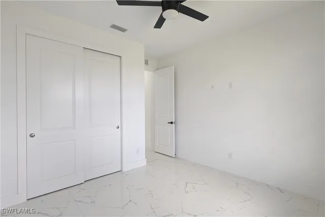 a view of a room with a ceiling fan