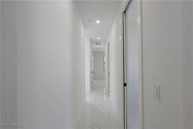 a view of a hallway with an entryway door