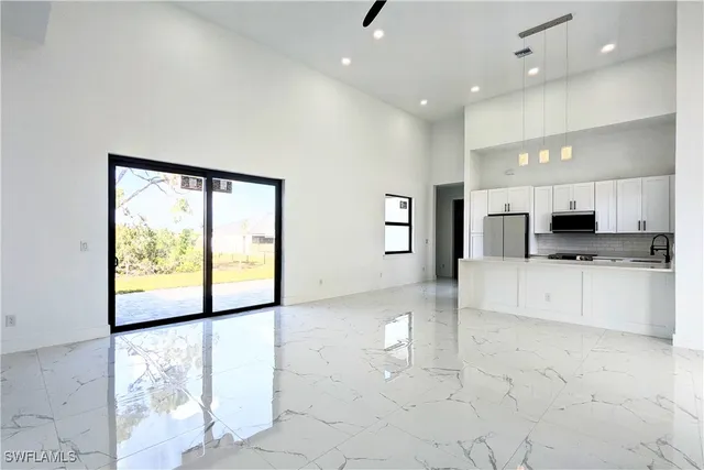 a view of kitchen with stainless steel appliances refrigerator oven and cabinets