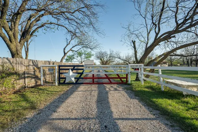 a view of a field with trees in background