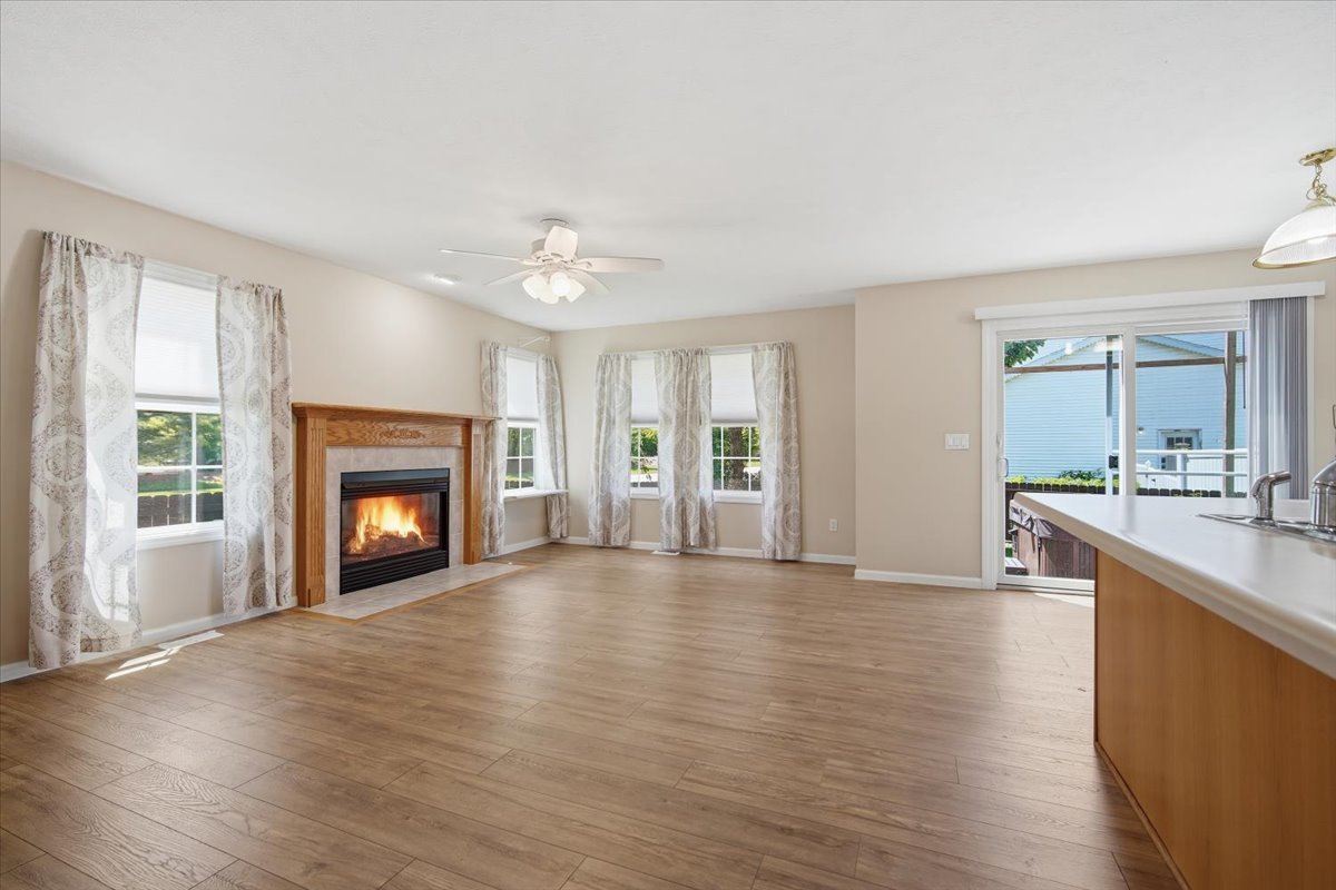 311 Old Farm Road Bloomington, IL 61704 - Photo 4 of 34 a view of an empty room with a fireplace and a window