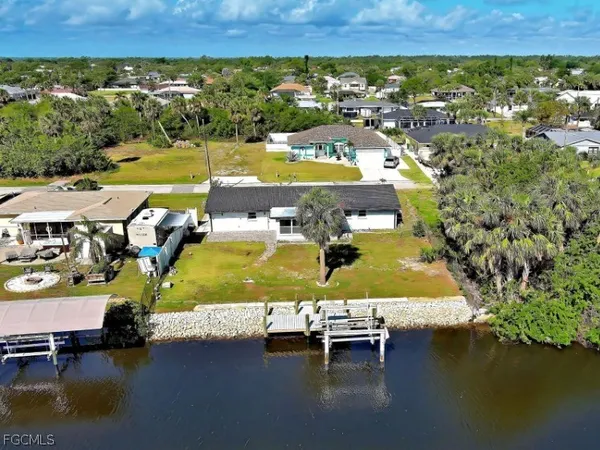 a view of kitchen with refrigerator and window