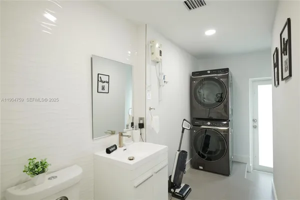 a bathroom with a sink mirror and toilet
