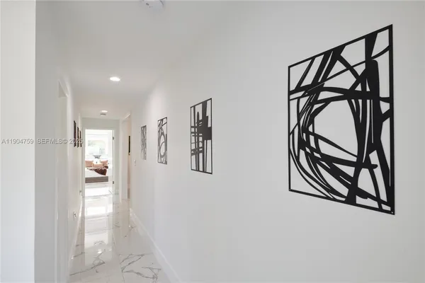 a view of a hallway with paintings on the wall