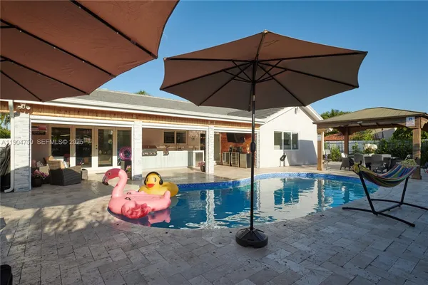 a view of a patio with couches table and chairs and potted plants