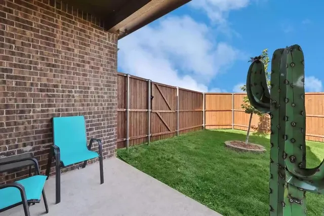 a backyard of a house with table and chairs