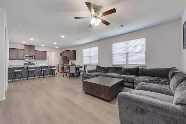 a living room with furniture and kitchen view