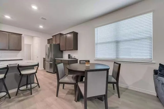 a kitchen with a table chairs sink and microwave