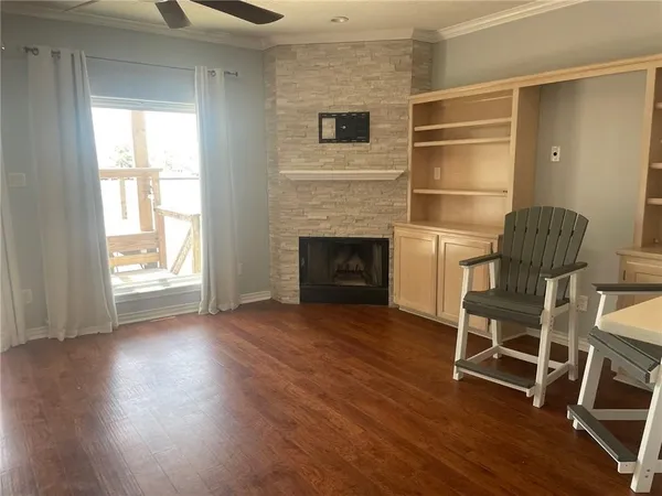 a living room with wooden floors and a fireplace