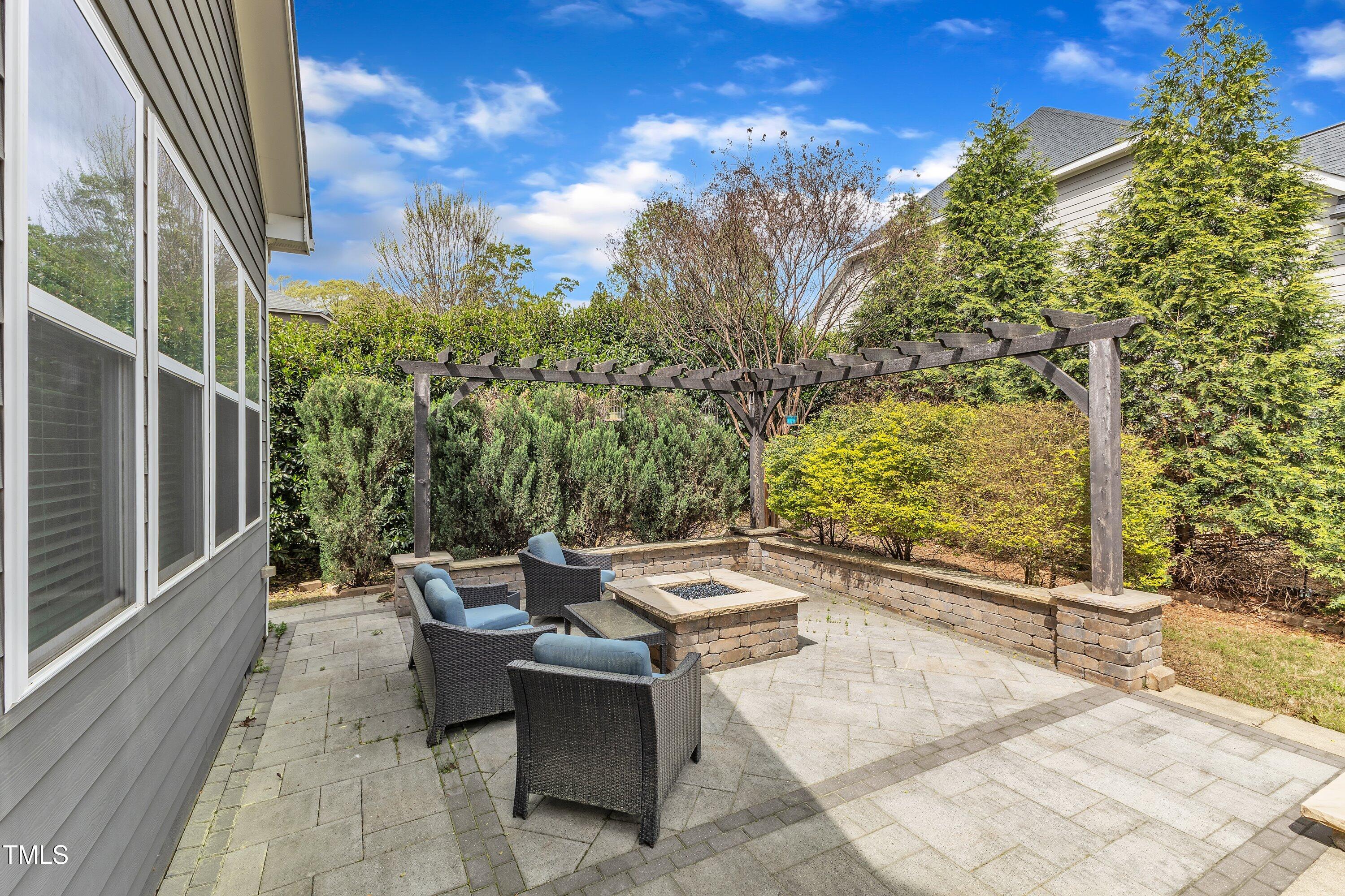 8121 Greys Landing Way Raleigh, NC 27615 - Photo 65 of 95 a backyard of a house with table and chairs