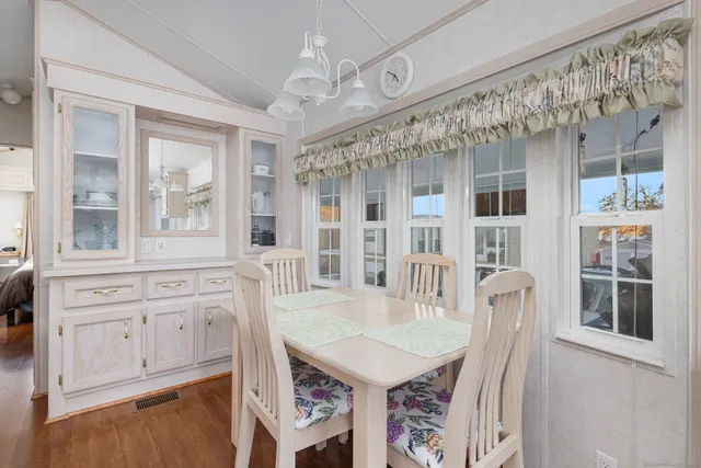 a view of a dining room with furniture window and wooden floor