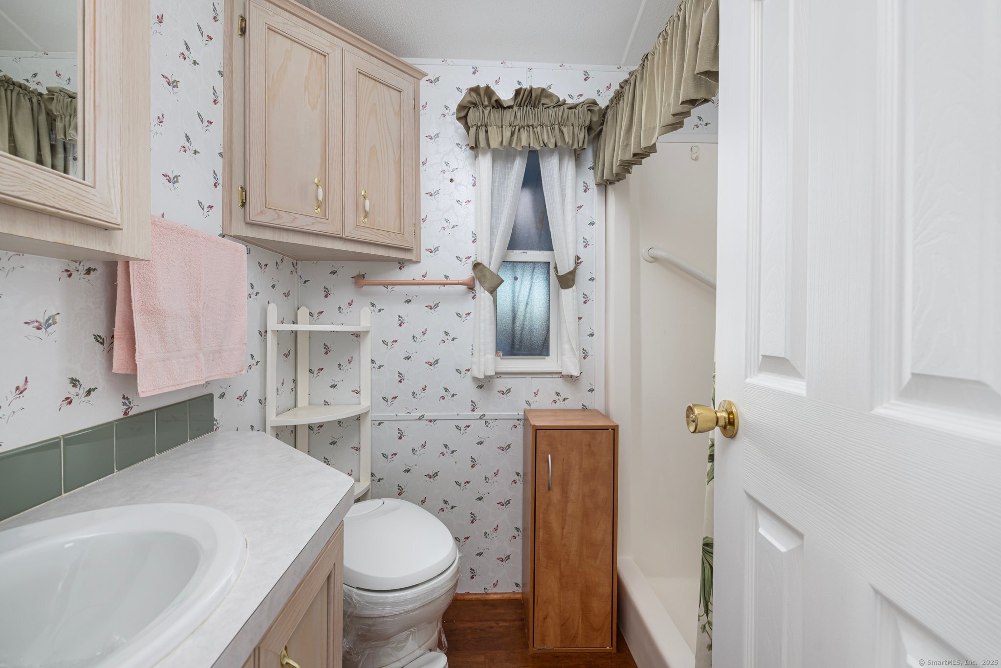 262 Shetucket Turnpike, Unit 69 Griswold, CT 06351 - Photo 22 of 37 a bathroom with a sink a toilet and shower