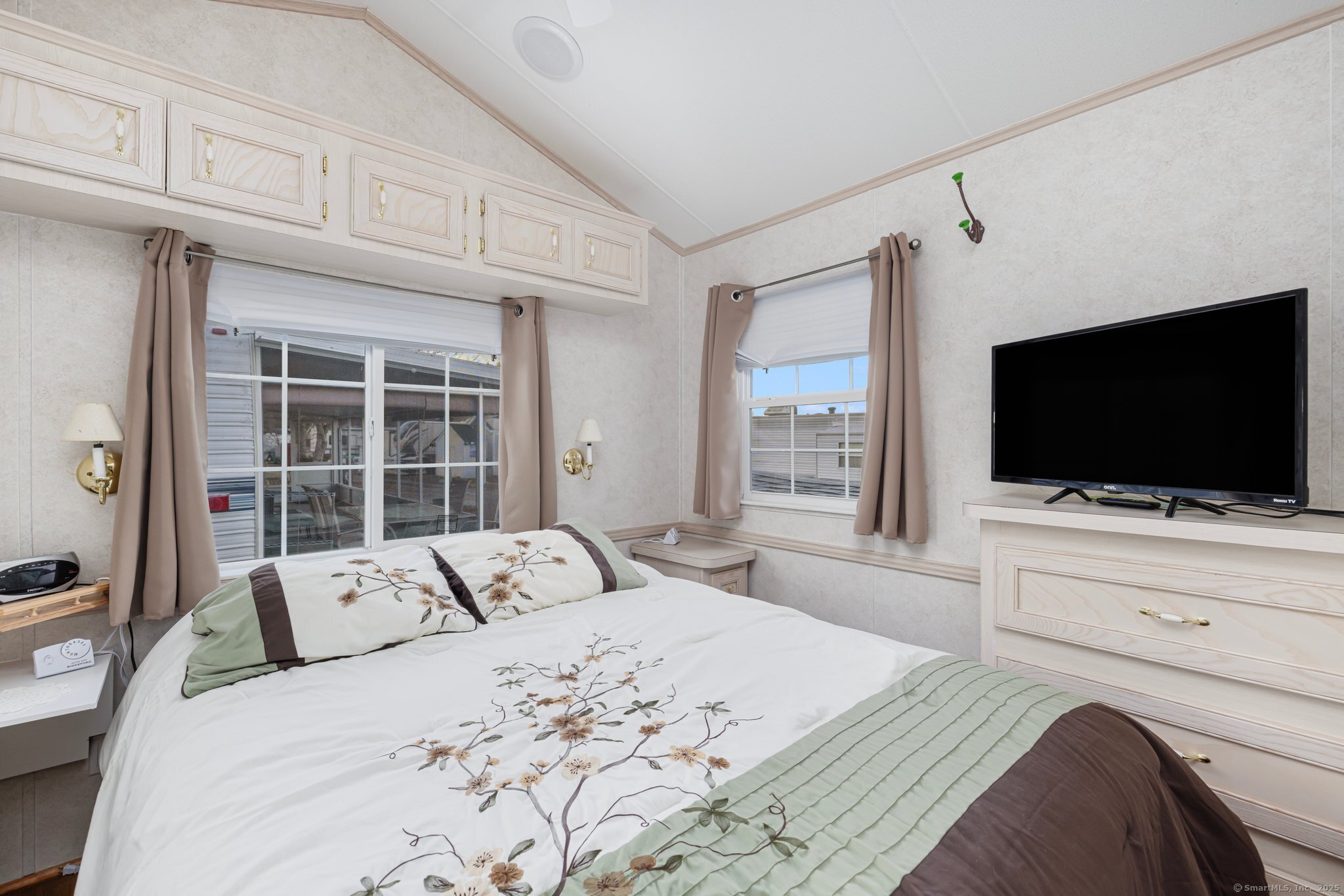 262 Shetucket Turnpike, Unit 69 Griswold, CT 06351 - Photo 24 of 37 a bedroom with a large bed and a flat screen tv