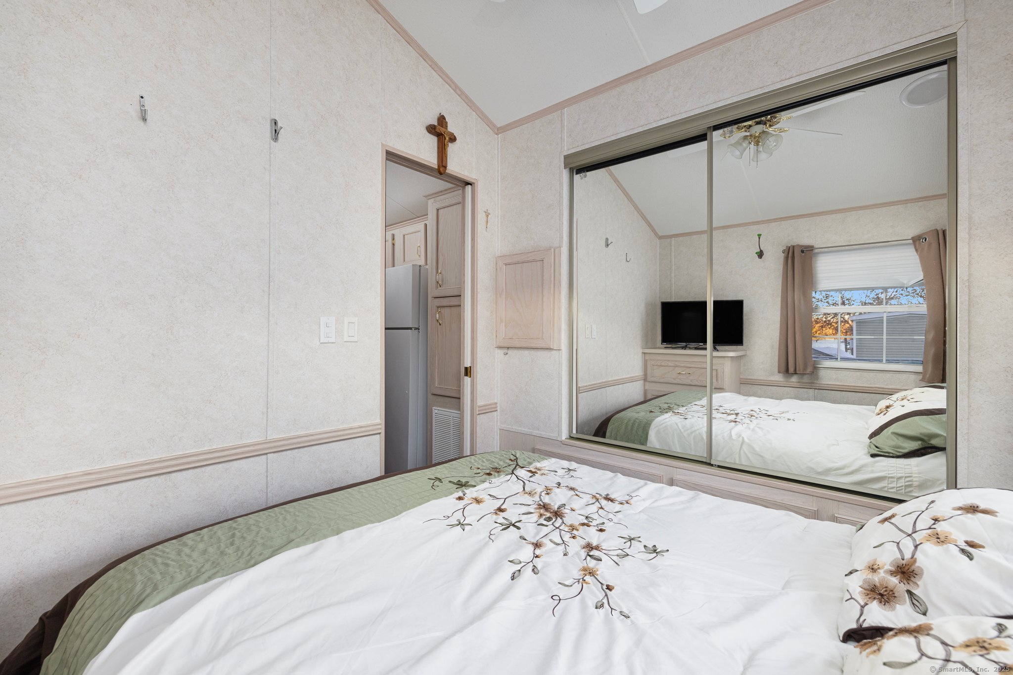 262 Shetucket Turnpike, Unit 69 Griswold, CT 06351 - Photo 25 of 37 a bedroom with a bed and a large mirror