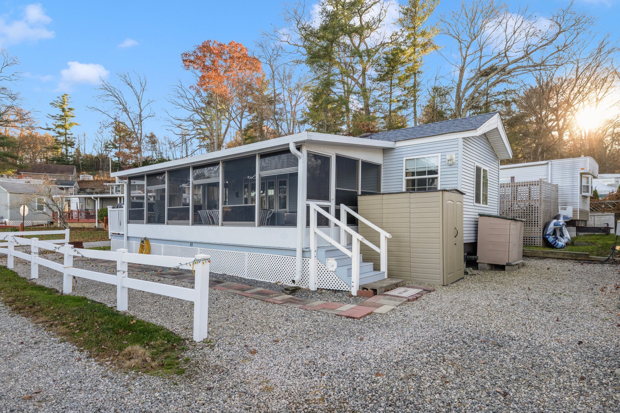 262 Shetucket Turnpike, Unit 69 Griswold, CT 06351 - Photo 4 of 37 a view of a house with a yard and garage