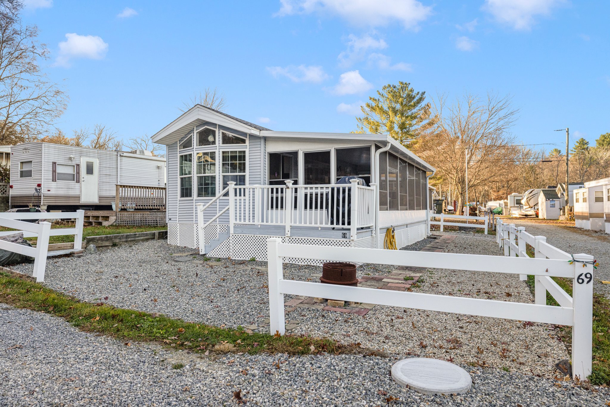262 Shetucket Turnpike, Unit 69 Griswold, CT 06351 - Photo 7 of 37 a front view of a house with a yard