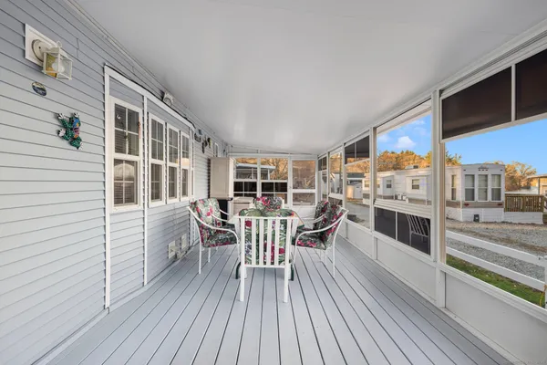 a balcony with furniture and wooden floor