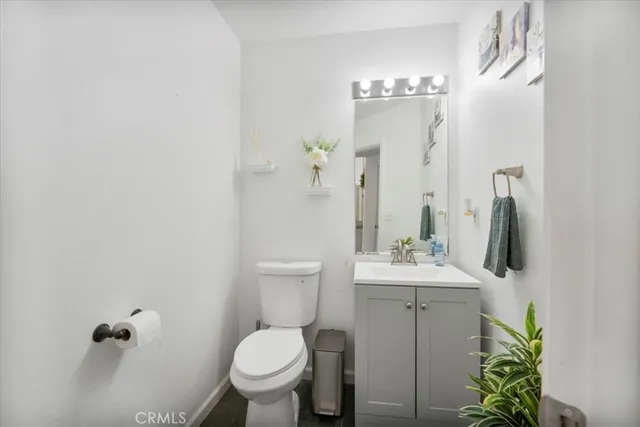 a bathroom with a sink toilet and mirror