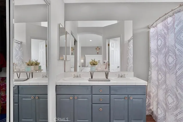 a bathroom with a double vanity sink mirror and