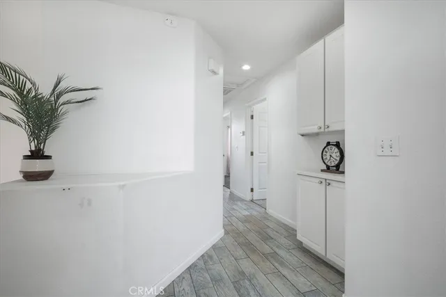 a view of hallway with wooden floor