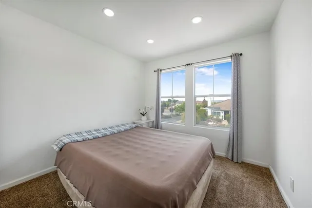 a bedroom with a bed and a mirror