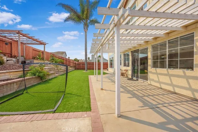 a view of a swimming pool with a lawn chairs and potted plants