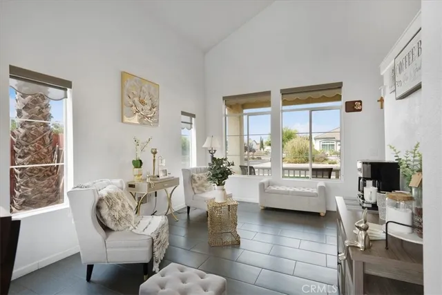 a living room with fireplace furniture and a large window