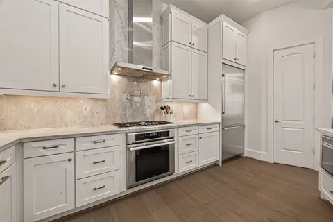 a kitchen with cabinets stainless steel appliances and a counter space