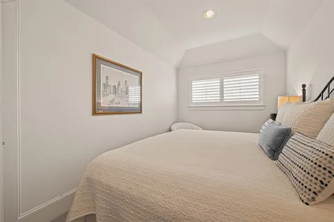 a bedroom with a large bed and a dresser